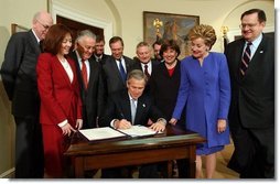 President George W. Bush signs H.R. 2622, the Fair and Accurate Credit Transactions Act of 2003, into law during a ceremony in the Roosevelt Room Thursday, December 4, 2003. White House photo by Tina Hager.